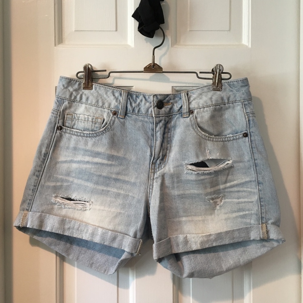 Low rise distressed and ripped denim shorts